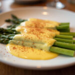 Finished Asparagus with Hollandaise Sauce, garnished and ready to serve.