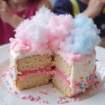 Finished classic cotton candy cake decorated with cotton candy and sprinkles, a delightful dessert.