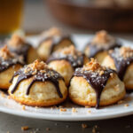 Delicious coconut macaroons drizzled with chocolate, perfect for any dessert table.