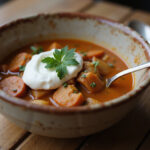 Bowl of finished high protein soup with parsley and Greek yogurt.