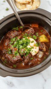 A steaming bowl of beef birria garnished with fresh cilantro and chopped onions, served alongside warm corn tortillas on a rustic wooden table, with vibrant red and brown hues highlighting the rich, flavorful stew's textures.